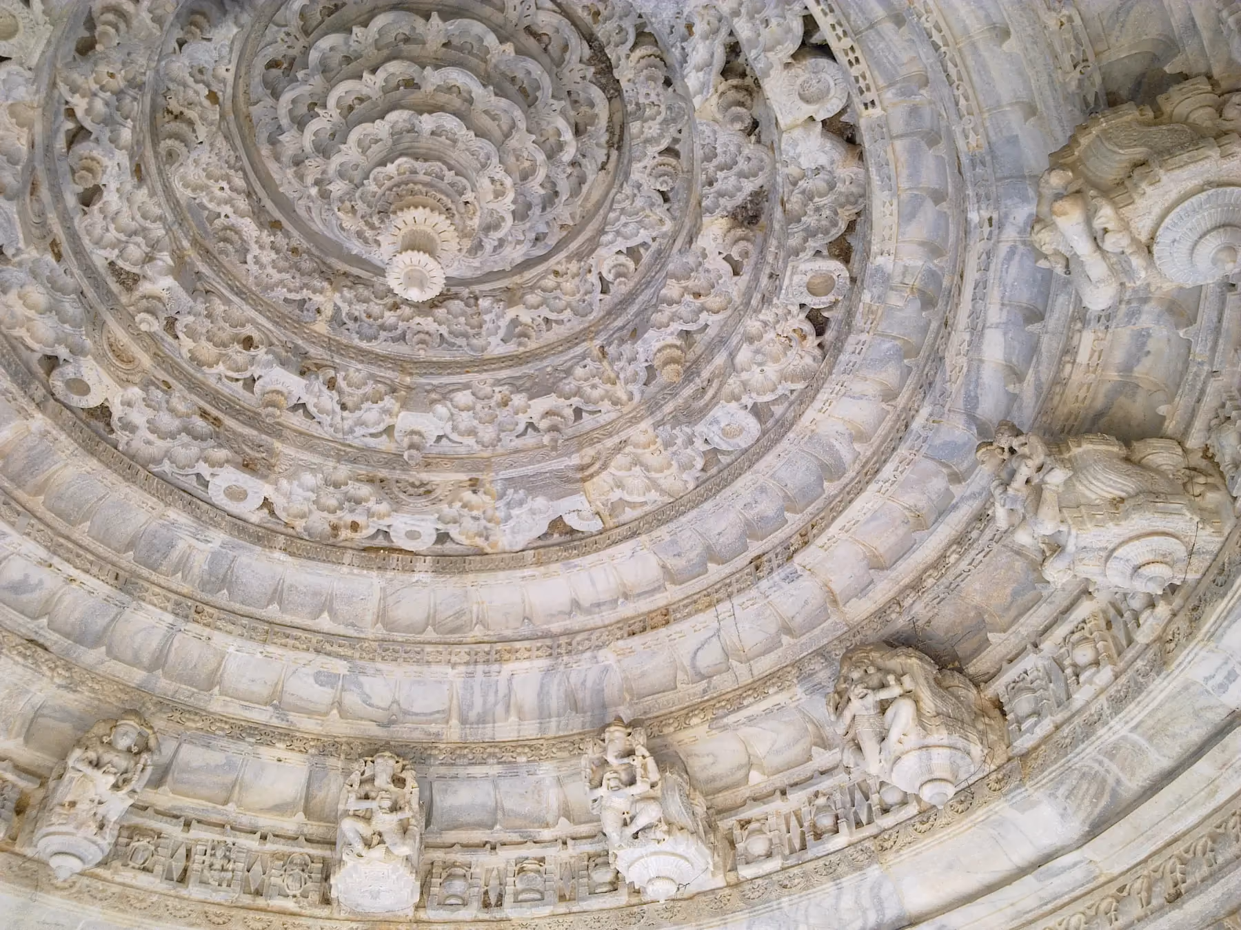 Carved figures and floral bands inside the dome of the Mirpur Jain temple
