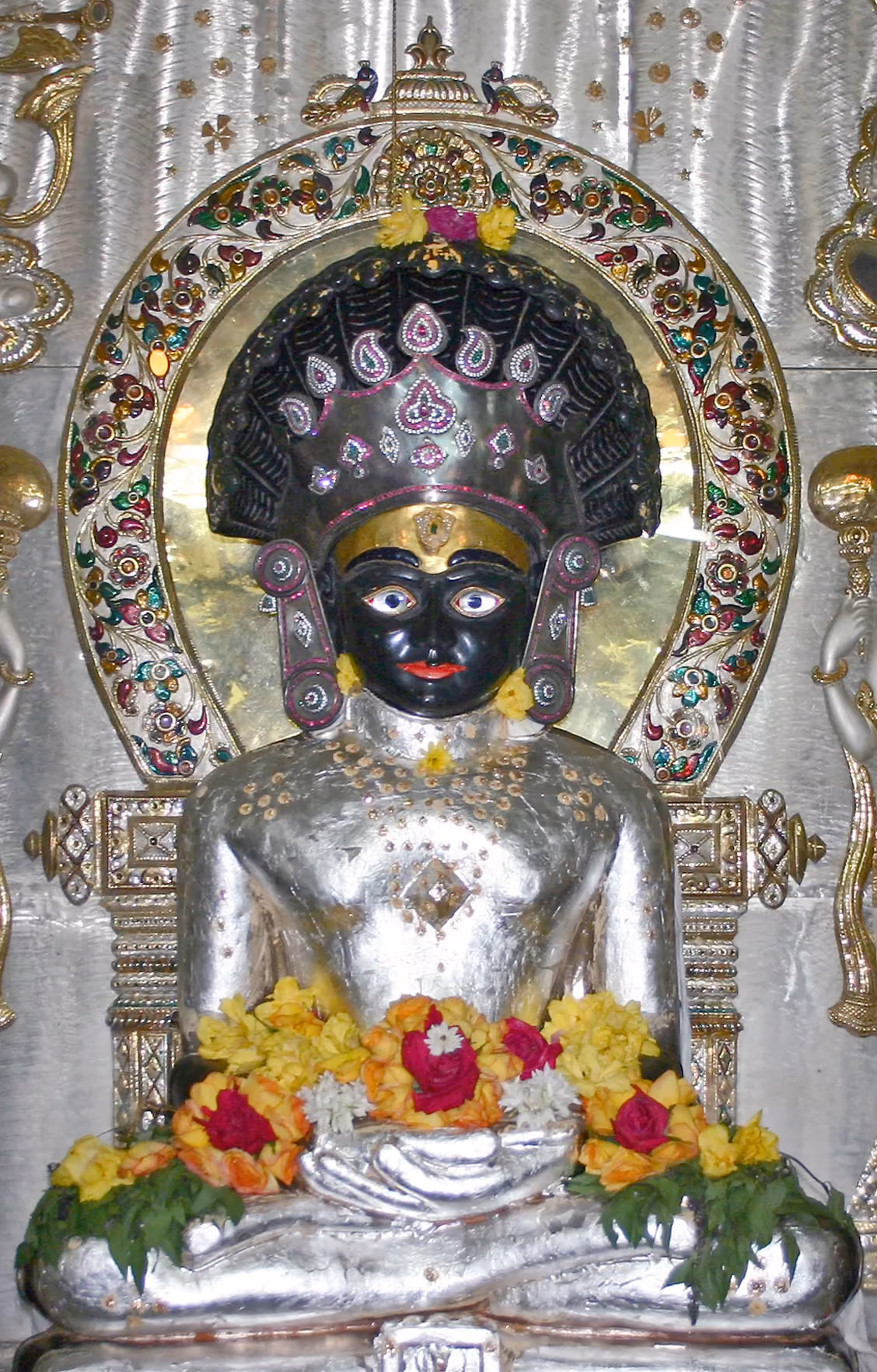 A seated Tirthankara idol enshrined inside a Jain temple in Mumbai