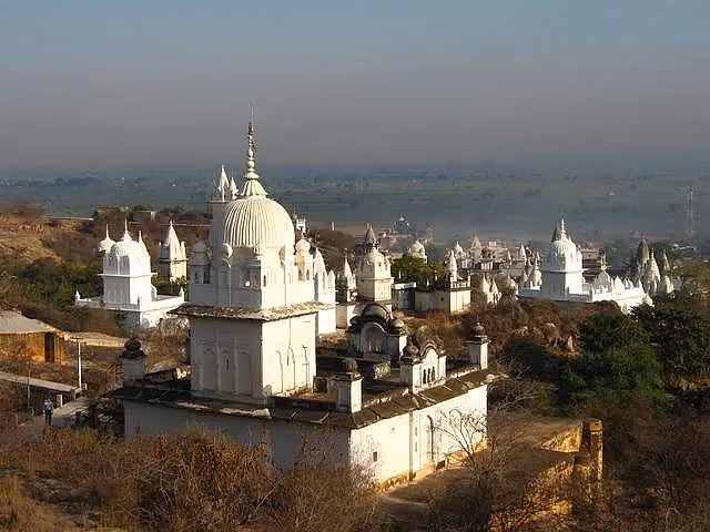 Whitewashed Digambar Jain temples scattered across the Sonagiri hillside under an open sky